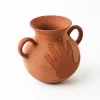 Pot with handle and hand in red clay