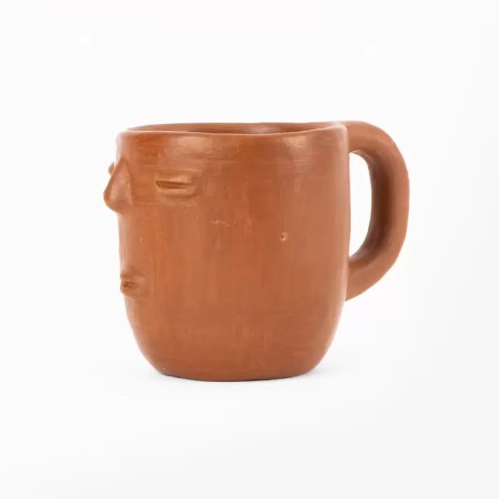Taza de barro rojo con diseño de cara