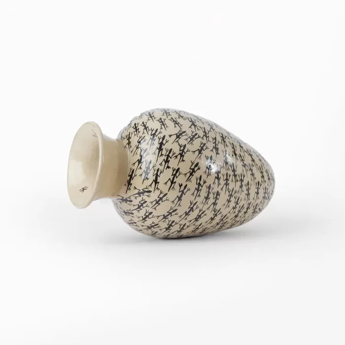White vase with lizard design