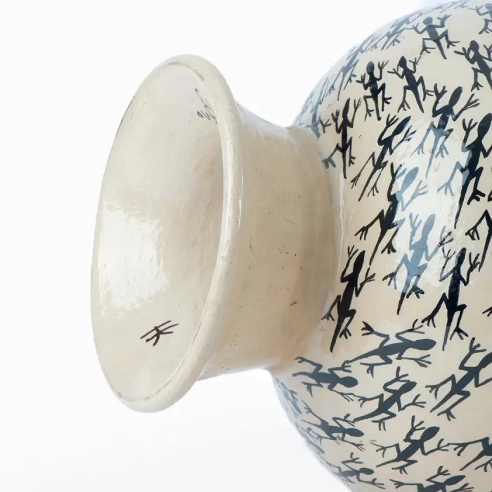 White vase with lizard design