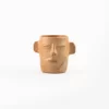 Vase with face and ears of natural clay
