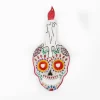 Calavera de hojalata con vela