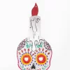 Calavera de hojalata con vela