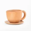 Natural terracotta colored earthenware cup and saucer