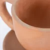 Natural terracotta colored earthenware cup and saucer