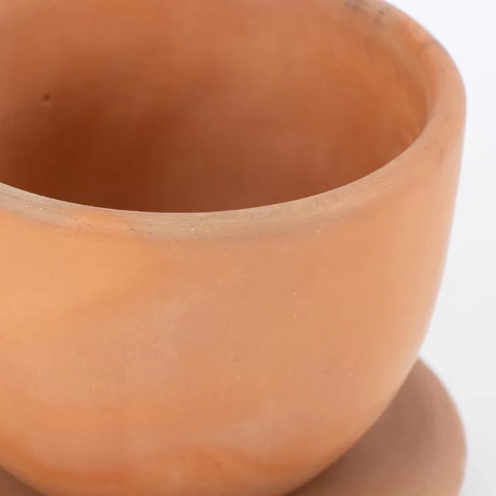 Natural terracotta colored earthenware cup and saucer