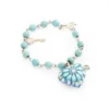 Pulsera de piedras de colores con dije de madera
