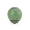 Black clay pot, green paint